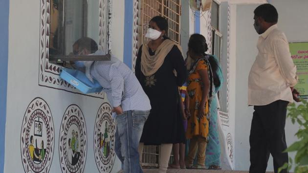 People stand in a queue for free medicine to help prevent Covid-19 at a government health center in Hyderabad.(AP)