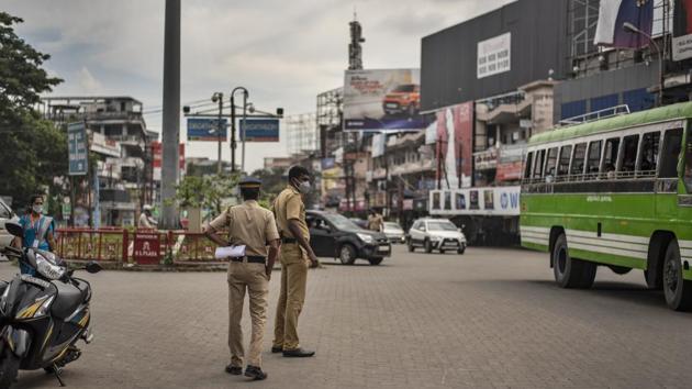 Policemen keep watch after the state government imposed prohibitory orders in the wake of rising coronavirus cases in Kochi on October 3. The first death due to Covid-19 was reported on March 12 in Karnataka, with the 100,000th fatality coming 204 days later. If India’s fatalities are divided into four phases of 25,000 deaths each, each has become shorter than the one preceding one. (R S Iyer / AP)