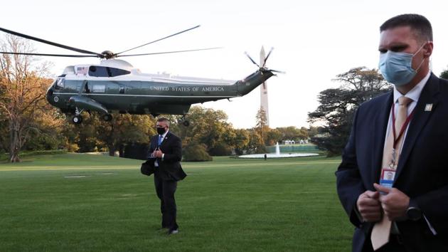 US Secret Service agents stand at their posts as the Marine One helicopter with US President Donald Trump on-board lifts off to depart for Walter Reed National Military Medical Center, at the White House in Washington, DC on October 2. Trump tweeted on October 2 that he and the first lady had tested positive for the virus, also adding “will begin our quarantine and recovery process immediately.” (Leah Millis / REUTERS)