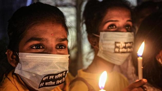 Activists light candles during a protest against the death of a 19-year-old Dalit woman who was allegedly gang-raped in UP’s Hathras, in Bhopal.(PTI Photo) Activists light candles during a protest against the death of a 19-year-old Dalit woman who was allegedly gang-raped in UP’s Hathras, in Bhopal.(PTI Photo)