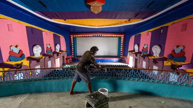 A worker cleans a cinema hall as part of preparations for a possible reopening, in Chennai on October 3. India is preparing to reopen cinemas and entertainment parks with limited capacity beginning October 15, in an effort to bring the economy up to speed. The move comes with potential for the virus to spread during the upcoming religious festival and winter season. (Arun Sankar / AFP)