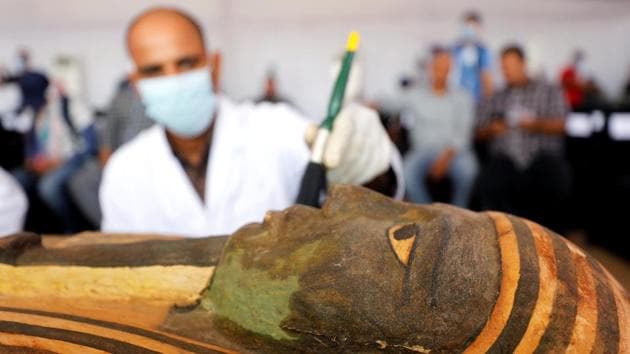 A sarcophagus is cleaned during a preview at Egypt's Saqqara necropolis on October 3. El-Anany told AP that the Saqqara coffins will join 30 ancient wooden coffins that were discovered earlier in the southern city of Luxor, and will be showcased at the new Grand Egyptian Museum, which Egypt is building near the Giza Pyramids. (Mohamed Abd El Ghany / REUTERS)