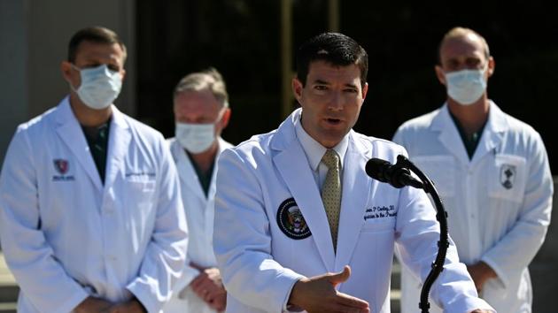 US Navy Commander Dr. Sean Conley, the White House physician, is flanked by other doctors as he speaks to the media about US President Donald Trump's health after the president was hospitalized for the coronavirus disease (Covid-19) treatment, at Walter Reed National Military Medical Center in Bethesda, Maryland, US.(REUTERS)