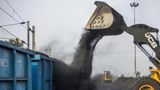 A JC Bamford Excavators Ltd. (JCB) front loader loads coal onto a freight wagon at the Tori Siding on the Tori-Shivpur rail line, operated by Indian Railways and funded by Coal India Ltd. in Chandwa, Jharkhand. (Bloomberg File Photo)