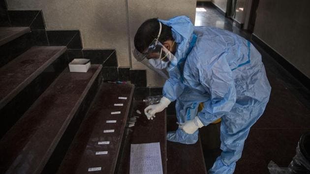 A health worker works with samples to test for Covid-19 in Srinagar on October 3. According to the ICMR, a cumulative total of 7,89,92,534 samples have been tested up to October 3 with 11,42,131 samples being tested on October 3.The health ministry stresses that more than 70% of the deaths due to the disease have occurred due to comorbidities. (Mukhar Khan / AP)