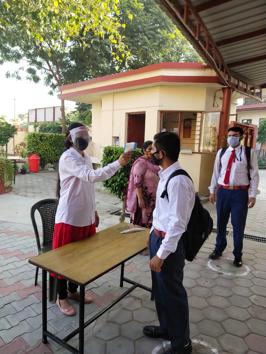 Students undergoing thermal screening at the entry gate of BCM School in Dugri on Monday. (HT photo) Students undergoing thermal screening at the entry gate of BCM School in Dugri on Monday. (HT photo)