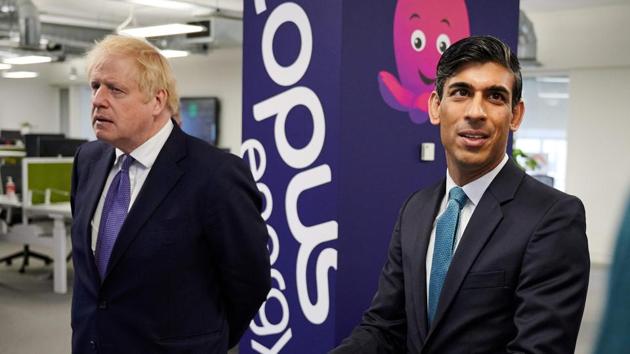 Britain's Prime Minister Boris Johnson (L) and Chancellor of the Exchequer Rishi Sunak talk with members of staff during their visit to the headquarters of energy supplier Octopus Energy in London on October 5. (AFP) Britain's Prime Minister Boris Johnson (L) and Chancellor of the Exchequer Rishi Sunak talk with members of staff during their visit to the headquarters of energy supplier Octopus Energy in London on October 5. (AFP)
