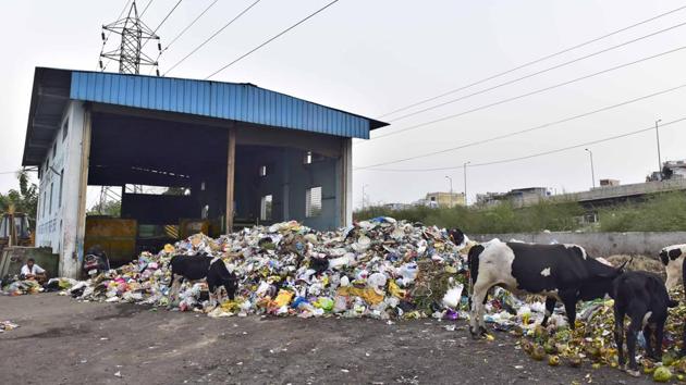 Garbage piles up outside the static waste compactor in Dugri road in Ludhiana on Monday. (Gurpreet Singh/HT)