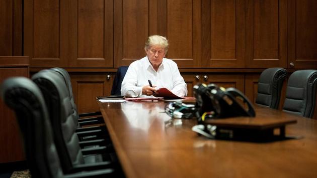US President Donald Trump seen working in his conference room at Walter Reed National Military Medical Center in Bethesda, Maryland on October 3. Trump, who has been repeatedly criticised for flouting public health guidelines and spreading misinformation on the pandemic, said in a video that dropped on Twitter just before the appearance that he had “learned a lot about Covid” by “really going to school” as he has battled the virus, AFP reported. (Joyce N Boghosian / The White House / AFP)