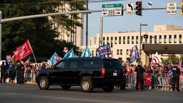 A vehicle in US President Trump's motorcade drives by supporters as they rally outside of Walter Reed Medical Center in Bethesda, Maryland on October 4, 2020. (AFP) A vehicle in US President Trump's motorcade drives by supporters as they rally outside of Walter Reed Medical Center in Bethesda, Maryland on October 4, 2020. (AFP)