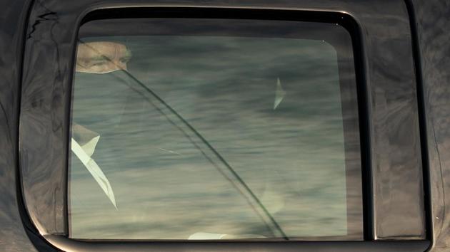 US President Trump looks on from the back of a car during the drive-by to greet his supporters outside Walter Reed Medical Center in Bethesda, Maryland on October 4. “Every single person in the vehicle during that completely unnecessary Presidential ‘drive-by’ just now has to be quarantined for 14 days,” James Phillips, chief of disaster medicine at George Washington University told AFP. (Alex Edelman / AFP)