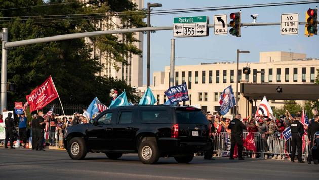 A vehicle in US President Trump’s motorcade drives past supporters as they rally outside Walter Reed Medical Center in Bethesda, Maryland on October 4. Experts criticised the move saying that the outing broke his own government’s public health guidelines requiring patients to isolate while they are in treatment and still shedding virus--and endangered his Secret Service protection. (Alex Edelman / AFP)