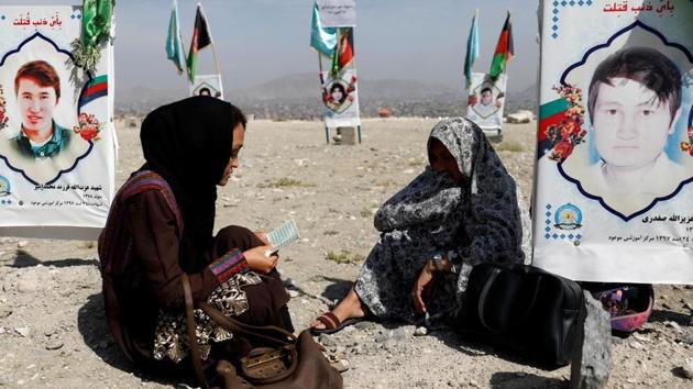 Relatives gather at a graveyard of the victims who were killed in a suicide attack in an educational centre two years ago, as Afghan government officials and the Taliban hold talks in Doha aimed at ending 19 years of war in the country, in Kabul. (REUTERS) Relatives gather at a graveyard of the victims who were killed in a suicide attack in an educational centre two years ago, as Afghan government officials and the Taliban hold talks in Doha aimed at ending 19 years of war in the country, in Kabul. (REUTERS)