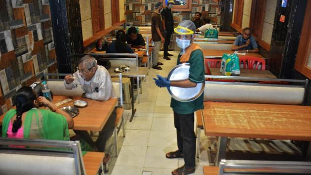 Patrons dine at a restaurant in Thane after eateries opened to dine-in services across Mahrashtra for the first time since the lockdown, on October 5. Maharashtra continues to lead the country in terms of both daily confirmed cases as well as recoveries being made from Covid-19. Karnataka and Andhra Pradesh round up the top three worst affected states. (Praful Gandurde / HT Photo)