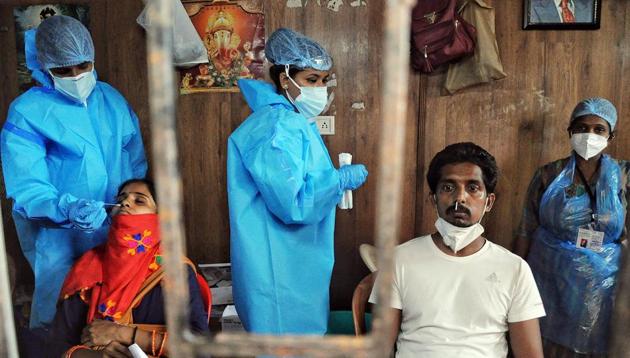 Heath workers in PPE kits collect a nasal samples for the Covid test, in Mumbai on Saturday. (ANI photo) Heath workers in PPE kits collect a nasal samples for the Covid test, in Mumbai on Saturday. (ANI photo)