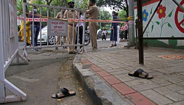 The footwear of real estate developer Rajesh Kanabar lying at the crime spot, cordoned off by police officials, after he was shot dead by a pedestrian outside treasury office, near Pune district collector building, on Monday. (RAVINDRA JOSHI/HT) The footwear of real estate developer Rajesh Kanabar lying at the crime spot, cordoned off by police officials, after he was shot dead by a pedestrian outside treasury office, near Pune district collector building, on Monday. (RAVINDRA JOSHI/HT)