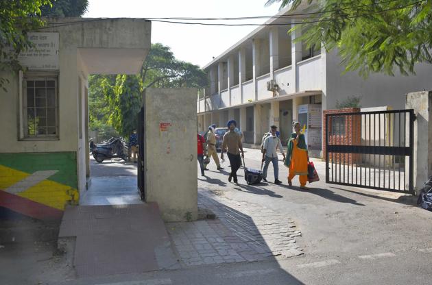 Patients leaving after the isolation centre was closed at the Government Senior Secondary Residential School for Meritorious Students in Ludhiana on Tuesday. (Harsimar Pal Singh/HT)