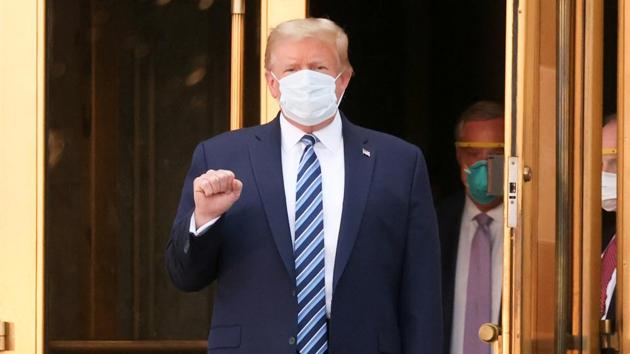 US President Donald Trump makes a fist as he walks out the front doors of Walter Reed National Military Medical Center after a fourth day of treatment for the coronavirus disease (Covid-19) while returning to the White House in Washington from the hospital.(Reuters Photo)