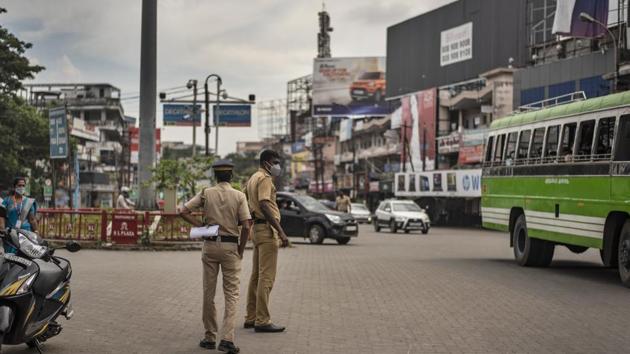 Policemen keep watch after the state government imposed prohibitory orders in the wake of rising coronavirus cases in Kochi, Kerala. (AP) Policemen keep watch after the state government imposed prohibitory orders in the wake of rising coronavirus cases in Kochi, Kerala. (AP)