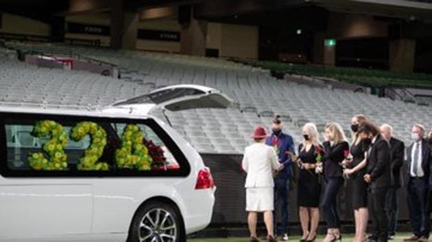 Family members of former Australian cricketer Dean Jones gather at the MCG in Melbourne as the deceased cricketer’s body is taken for a final lap around the stadium during a private funeral.(Twitter/Cricket Australia)
