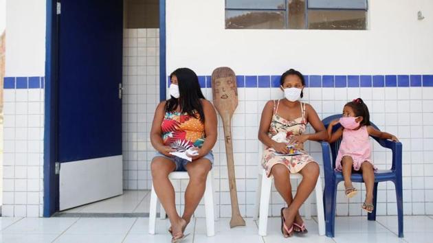 Women from the Guajajara ethnic group wait during health screenings by the military in Morro Branco on October 4. Carlos Travassos, a former head of isolated tribes at the government’s indigenous affairs agency Funai, told Reuters the medical outreach was just a media operation. “This was just for Englishmen to see,” he said, using a Brazilian expression for doing things for the sake of appearances. (Adriano Machado / REUTERS)