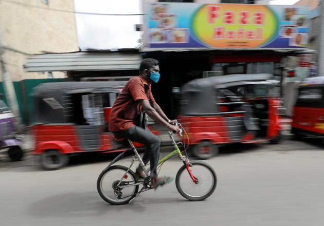 A man wearing a protective mask rides a bike on main road, amid concerns about the spread of the coronavirus disease (Covid-19), in Colombo (REUTERS/Dinuka Liyanawatte) A man wearing a protective mask rides a bike on main road, amid concerns about the spread of the coronavirus disease (Covid-19), in Colombo (REUTERS/Dinuka Liyanawatte)