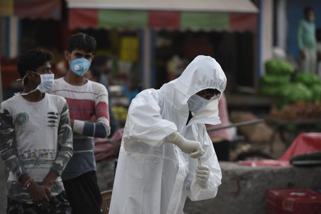 A health worker preserves a swab sample for coronavirus test at Khandsa road, in Gurugram (Photo by Parveen Kumar/Hindustan Times) A health worker preserves a swab sample for coronavirus test at Khandsa road, in Gurugram (Photo by Parveen Kumar/Hindustan Times)