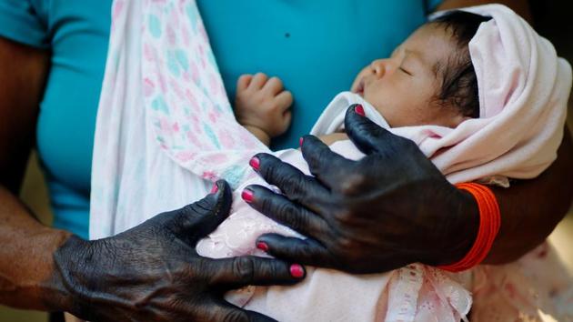 A woman from the Guajajara ethnic group holds a child in the village of Morro Branco on October 4. Guajajara leaders have praised the armed forces for air lifting doctors and nurses to do rapid Covid-19 tests and examine for other diseases, but also criticized the government’s indigenous health service SESAI for not protecting them against the novel coronavirus, Reuters reports. (Adriano Machado / REUTERS)