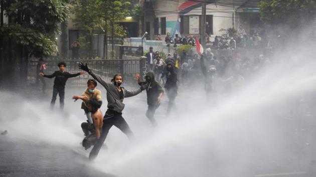 Riot police use a water cannon to disperse student protesters on the second day of a three-day strike by labourers against a government omnibus bill on job creation, in Bandung on October 7. More than 3,000 protesters attempted to reach the heavily guarded parliament. Protesters set fires to tires near blocked streets and pelted police with rocks and gasoline bombs and broke down a gate of the parliament compound. (Timur Matahari / AFP) Riot police use a water cannon to disperse student protesters on the second day of a three-day strike by labourers against a government omnibus bill on job creation, in Bandung on October 7. More than 3,000 protesters attempted to reach the heavily guarded parliament. Protesters set fires to tires near blocked streets and pelted police with rocks and gasoline bombs and broke down a gate of the parliament compound. (Timur Matahari / AFP)