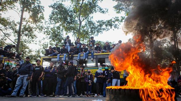 University students protest the government's labour reforms bill in Tangerang, on the outskirts of Jakarta on October 7. Smaller protests also occurred in other Indonesian cities, including in Jakarta’s satellite cities of Tangerang and Bekasi where large factories are located, and many cities on Sumatra and Sulawesi islands. (Fauzan / Antra Foto via REUTERS) University students protest the government's labour reforms bill in Tangerang, on the outskirts of Jakarta on October 7. Smaller protests also occurred in other Indonesian cities, including in Jakarta’s satellite cities of Tangerang and Bekasi where large factories are located, and many cities on Sumatra and Sulawesi islands. (Fauzan / Antra Foto via REUTERS)