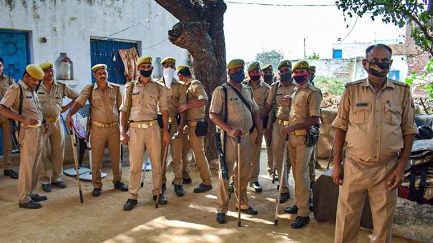 The police seen outside the Hathras family home. The family was recently provided a three-tier police security cover. (HT Photo)