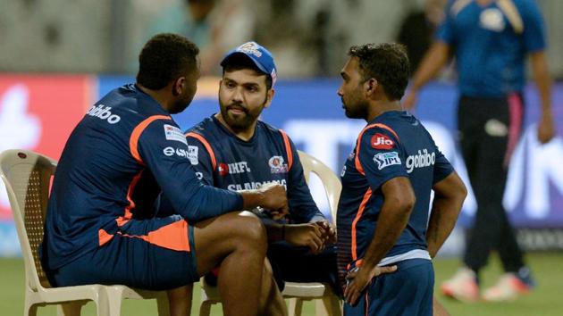 Mumbai Indians captain Rohit Sharma (C) speaks with coach Mahela Jayawardene (R) and a teammate Kieron Pollard during a training session.(AFP)