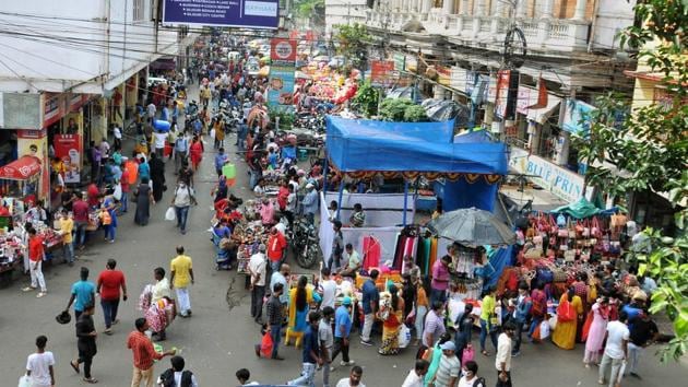 People shopping ahead of the upcoming Durga Puja festival at New Market amid the coronavirus pandemic in Kolkata on Wednesday.(PTI PHOTO.)