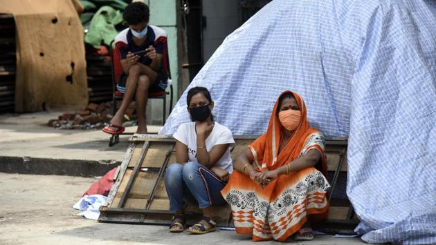 People wearing face masks wait for their turn at a Covid-19 sample collection and testing centre in New Delhi on October 7. A handful of states, particularly Kerala and Karnataka, however, appear to be defying the larger trend and cases there remain currently at peak levels and appear to be rising. (Biplov Bhuyan / HT Photo)
