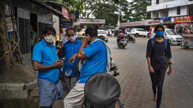 Porters wearing masks as a precaution against the coronavirus chat by a roadside in Kochi, Kerala. India is the world's second most coronavirus affected country after the United States. (Photo: AP) Porters wearing masks as a precaution against the coronavirus chat by a roadside in Kochi, Kerala. India is the world's second most coronavirus affected country after the United States. (Photo: AP)