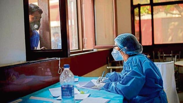 A health worker at a Delhi clinic speaks to a person before a Covid-19 test. (AP photo) A health worker at a Delhi clinic speaks to a person before a Covid-19 test. (AP photo)
