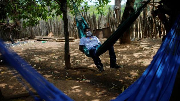 Jose Aldrinho Guajajara from the Guajajara indigenous ethnic group cured of the coronavirus disease is seen sitting on a hammock at the indigenous village of Bacurizinho in Maranhao state of Brazil on October 5. Despite a decline in cases, experts have warned of a possible second wave of infections that could emerge in early 2021. (Adriano Machado / Reuters)