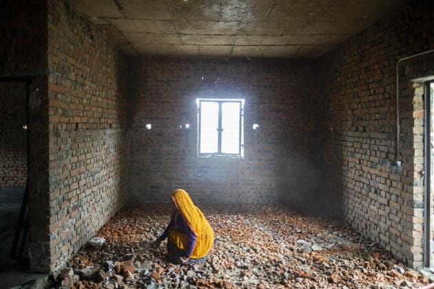 File photo of a labourer using a hammer to break bricks at the construction site of a house in Noida, Uttar Pradesh.(Bloomberg Photo)