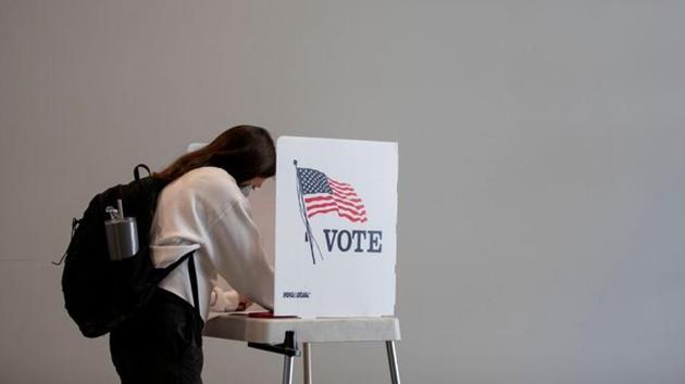 People cast their ballots for the upcoming presidential elections as early voting begins in Ann Arbor, Michigan, US on September 24, 2020.(Reuters Photo)