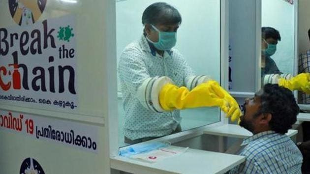 Medical staff members of a government-run medical college collect swabs from people to test for coronavirus disease (COVID-19) at a newly installed Walk-In Sample Kiosk (WISK) in Ernakulam, Kerala.(REUTERS) Medical staff members of a government-run medical college collect swabs from people to test for coronavirus disease (COVID-19) at a newly installed Walk-In Sample Kiosk (WISK) in Ernakulam, Kerala.(REUTERS)