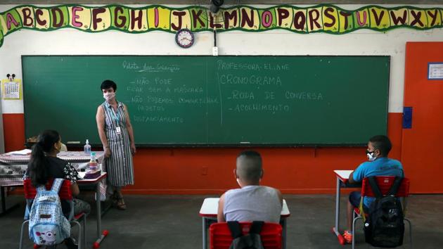 Eliane Conconi talks to her students in a classroom at Thomaz Rodrigues Alckmin School, on the first day of the return of Sao Paulo state’s schools amid coronavirus outbreak in Sao Paulo on October 7. According to data from Brazil’s statistical institutes - the percentage of people in strict isolation or leaving home only when necessary dropped to 57% in mid-September, from 68% in early July. (Amanda Perobelli / Reuters)