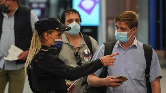 A police officer checks the documents of a passenger inside Atocha railway station in Madrid, Spain. (Bloomberg) A police officer checks the documents of a passenger inside Atocha railway station in Madrid, Spain. (Bloomberg)