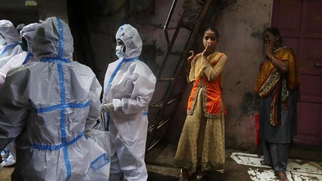 Health workers screen residents for Covid-19 symptoms at Dharavi, Mumbai. (AP) Health workers screen residents for Covid-19 symptoms at Dharavi, Mumbai. (AP)