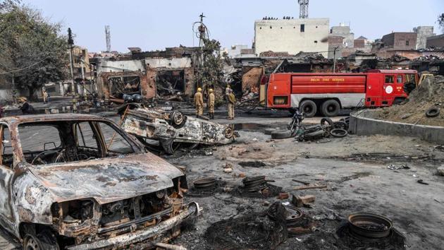 Firefighters stand near a fire rescue vehicle as they douse burnt-out tyre market premises following clashes between people supporting and opposing a contentious amendment to India's citizenship law, in New Delhi in February 2020. (AFP) Firefighters stand near a fire rescue vehicle as they douse burnt-out tyre market premises following clashes between people supporting and opposing a contentious amendment to India's citizenship law, in New Delhi in February 2020. (AFP)