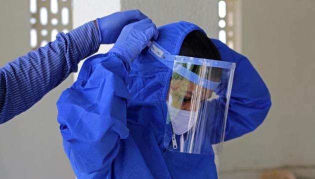 A health worker preparing for take swab of Covid 19 at a Covid 19 test centre in Pune. (Ravindra Joshi/HT Photo) A health worker preparing for take swab of Covid 19 at a Covid 19 test centre in Pune. (Ravindra Joshi/HT Photo)