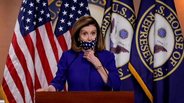 US House Speaker Nancy Pelosi adjusts her face mask as she announces her plans for Congress to create a "Commission on Presidential Capacity to Discharge the Powers and Duties of Office Act," after US President Donald Trump came down with coronavirus disease during a Capitol Hill news conference in Washington. (REUTERS) US House Speaker Nancy Pelosi adjusts her face mask as she announces her plans for Congress to create a "Commission on Presidential Capacity to Discharge the Powers and Duties of Office Act," after US President Donald Trump came down with coronavirus disease during a Capitol Hill news conference in Washington. (REUTERS)
