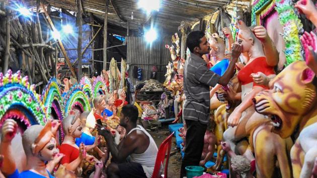 Artists give final touch to idols of Goddess Durga ahead of Durga Puja festival, in Bhopal.(PTI) Artists give final touch to idols of Goddess Durga ahead of Durga Puja festival, in Bhopal.(PTI)