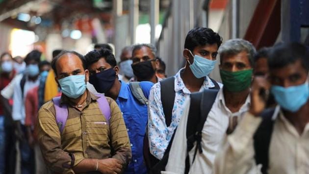 Passengers wearing protective face masks stand in a queue on a platform to get tested for the coronavirus disease (COVID-19), at a railway station in New Delhi in this file photo.(Reuters Photo) Passengers wearing protective face masks stand in a queue on a platform to get tested for the coronavirus disease (COVID-19), at a railway station in New Delhi in this file photo.(Reuters Photo)