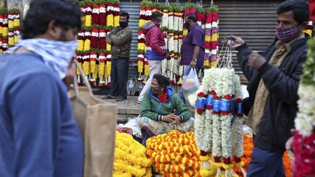Flower vendors wearing face masks as a precaution against coronavirus wait for buyers at a wholesale market in Bengaluru on Thursday, Sept. 24, 2020. The nation of 1.3 billion people is expected to become the pandemic's worst-hit country within weeks, surpassing the United States. (AP) Flower vendors wearing face masks as a precaution against coronavirus wait for buyers at a wholesale market in Bengaluru on Thursday, Sept. 24, 2020. The nation of 1.3 billion people is expected to become the pandemic's worst-hit country within weeks, surpassing the United States. (AP)