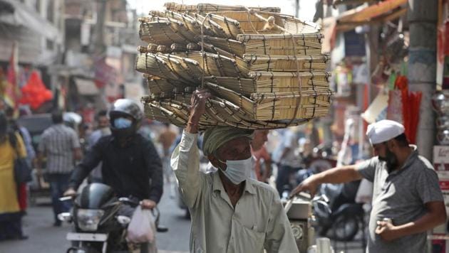An Indian villager wearing a face mask as a precaution against the coronavirus sells his ware at market in Jammu, India. (AP) An Indian villager wearing a face mask as a precaution against the coronavirus sells his ware at market in Jammu, India. (AP)